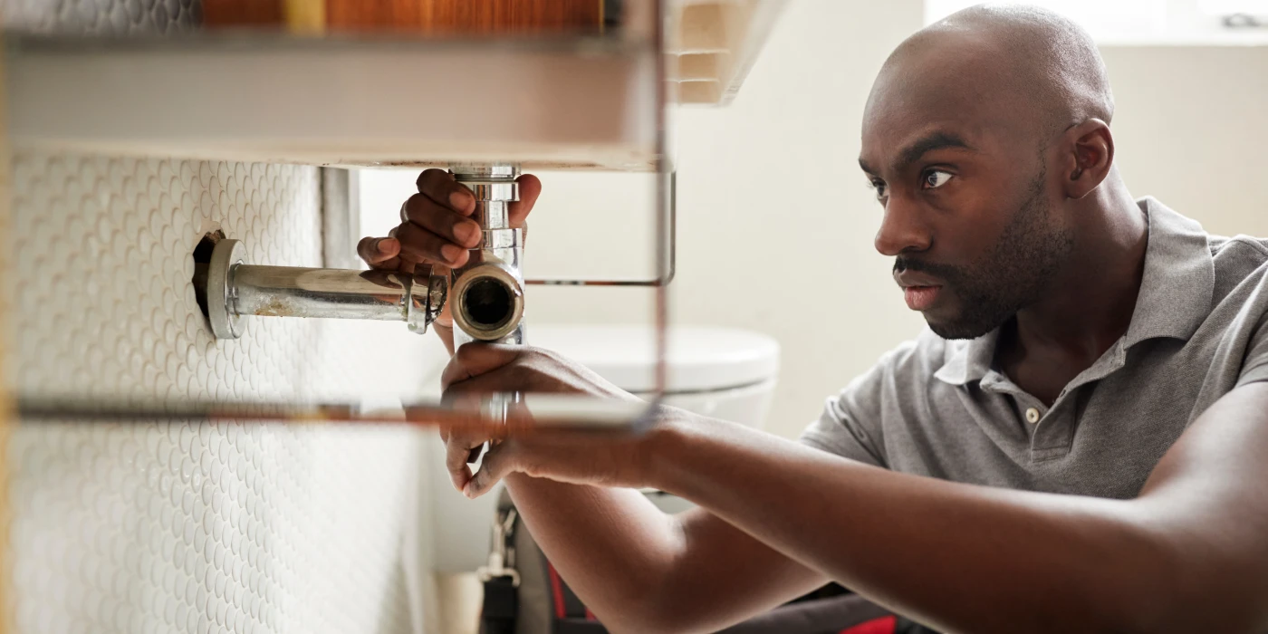 a male plumber fixing a pipe connection from Dallas TX Plumbing in Dallas, TX - Plumber near me a male plumber fixing a pipe connection from Dallas TX Plumbing in Dallas, TX - Plumber near me